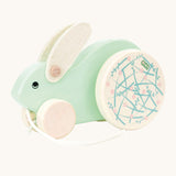 A mint green Bajo Big Rabbit toy. This pull along wooden toy has small wheels at the front and large decorated wheels at the back. The rabbit makes a jumping motion as it is being pulled along. We have a wide range of Bajo wooden toys available here at Babipur. 