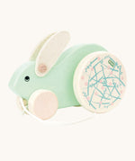 A mint green Bajo Big Rabbit toy. This pull along wooden toy has small wheels at the front and large decorated wheels at the back. The rabbit makes a jumping motion as it is being pulled along. We have a wide range of Bajo wooden toys available here at Babipur. 