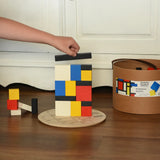 Child stacking blocks from the Bajo toys wooden Mondrian building blocks set.