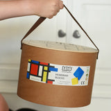 Bajo toys wooden Mondrian building blocks set box in a child's hand.