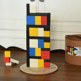 Blocks from the Bajo toys wooden Mondrian building blocks set stacked on top of each other.