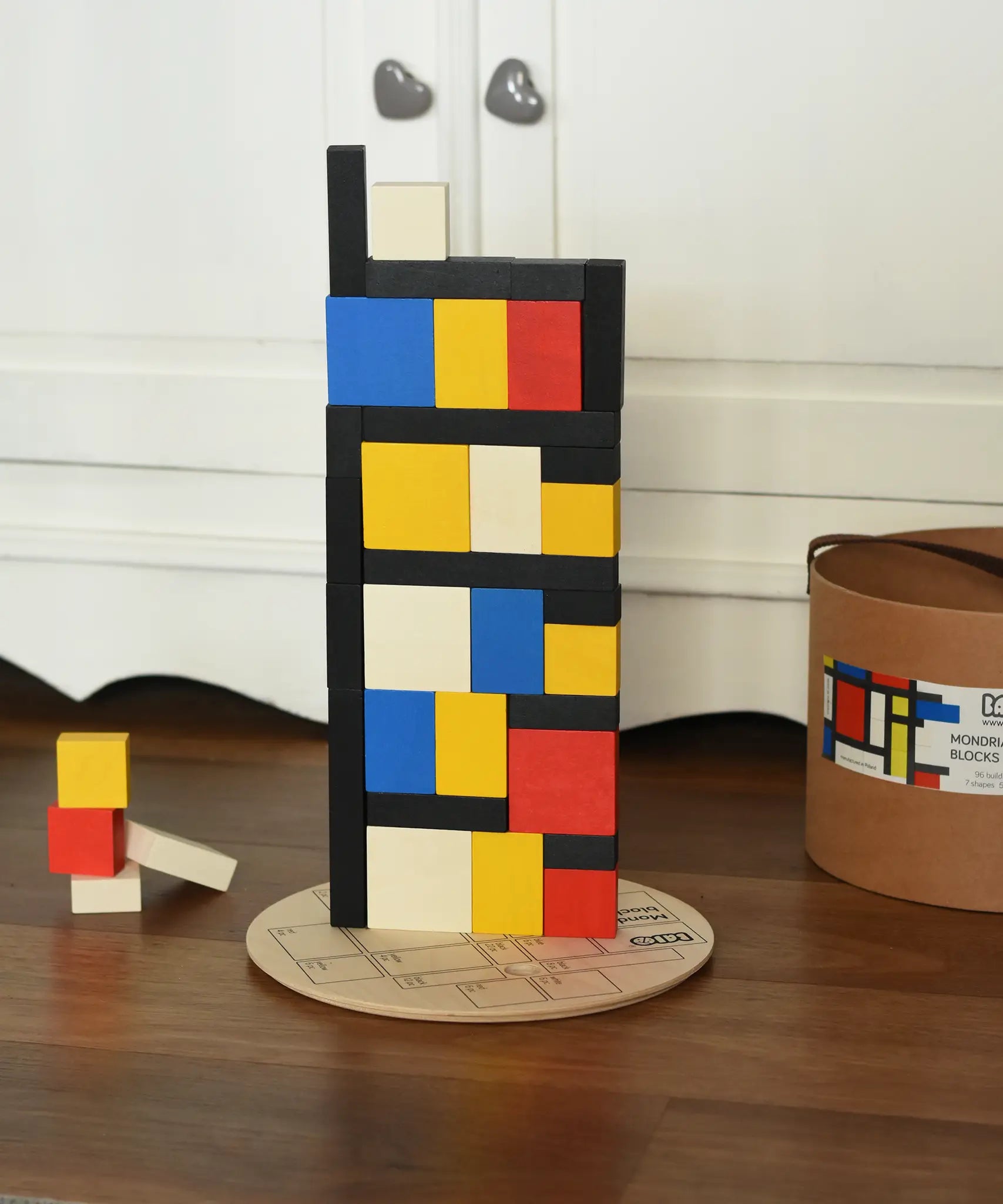 Blocks from the Bajo toys wooden Mondrian building blocks set stacked on top of each other.
