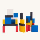 Bajo toys wooden Mondrian Building Blocks. A mix of black, white, yellow, red and blue coloured blocks in a box with square and rectangular shaped blocks.