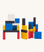 Bajo toys wooden Mondrian Building Blocks. A mix of black, white, yellow, red and blue coloured blocks in a box with square and rectangular shaped blocks.