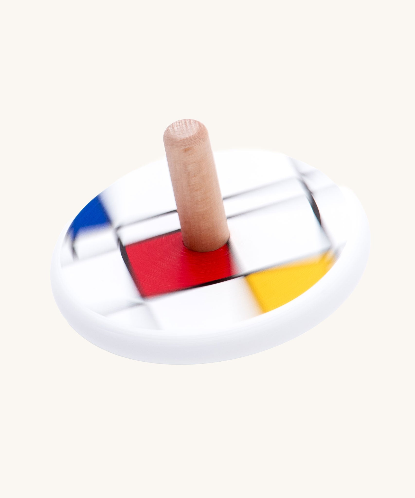 Bajo Mondrian Spinning Top. A white painted spinning top decorated with black, blue, red and yellow line designs.