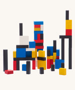 Bajo toys wooden Mondrian Building Blocks. A mix of black, white, yellow, red and blue coloured blocks in a box with square and rectangular shaped blocks.