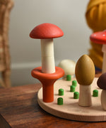 Two mushrooms from the Bajo Wooden Mushroom Forest Peg Puzzle stacked on top of each other. These heirloom quality toys by Bajo are part of a wide range of wooden toys available here at Babipur. 