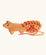 Bajo natural lacing fox threading toy.
