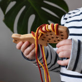 Bajo natural lacing fox in a child's hands in the Babipur playroom.