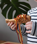 Bajo natural lacing fox in a child's hands in the Babipur playroom.