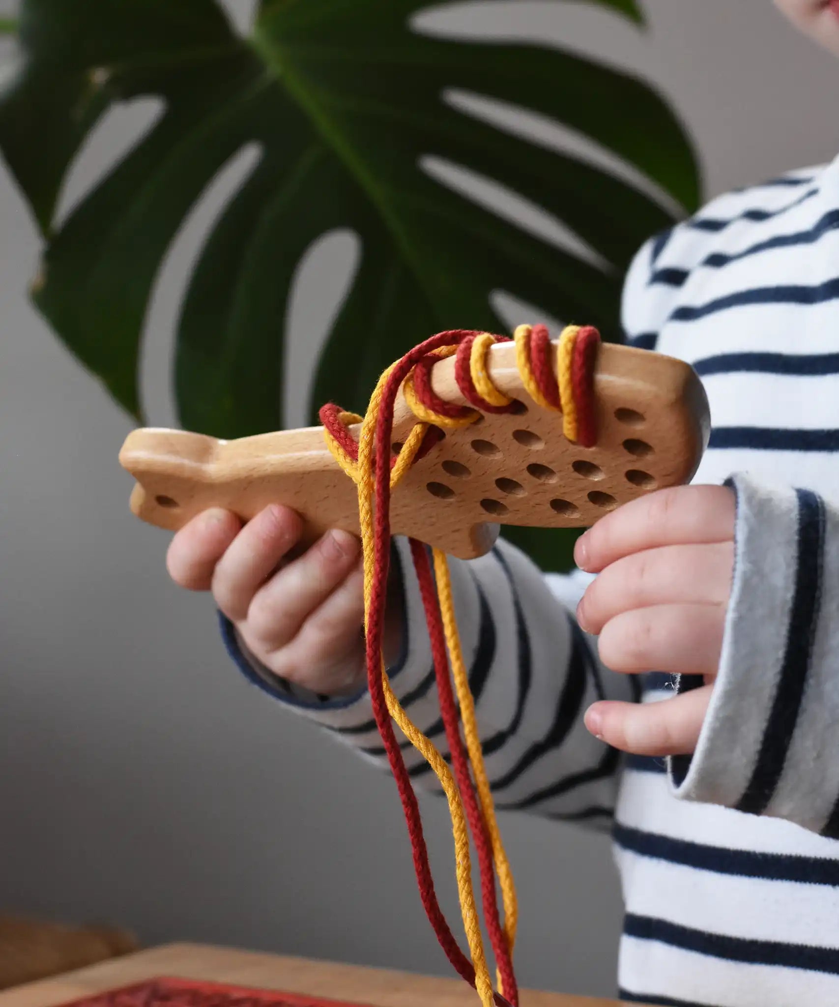 Bajo natural lacing fox in a child's hands in the Babipur playroom.