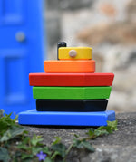 Bajo nemo boat stacker toy placed on a stone wall outdoors. 