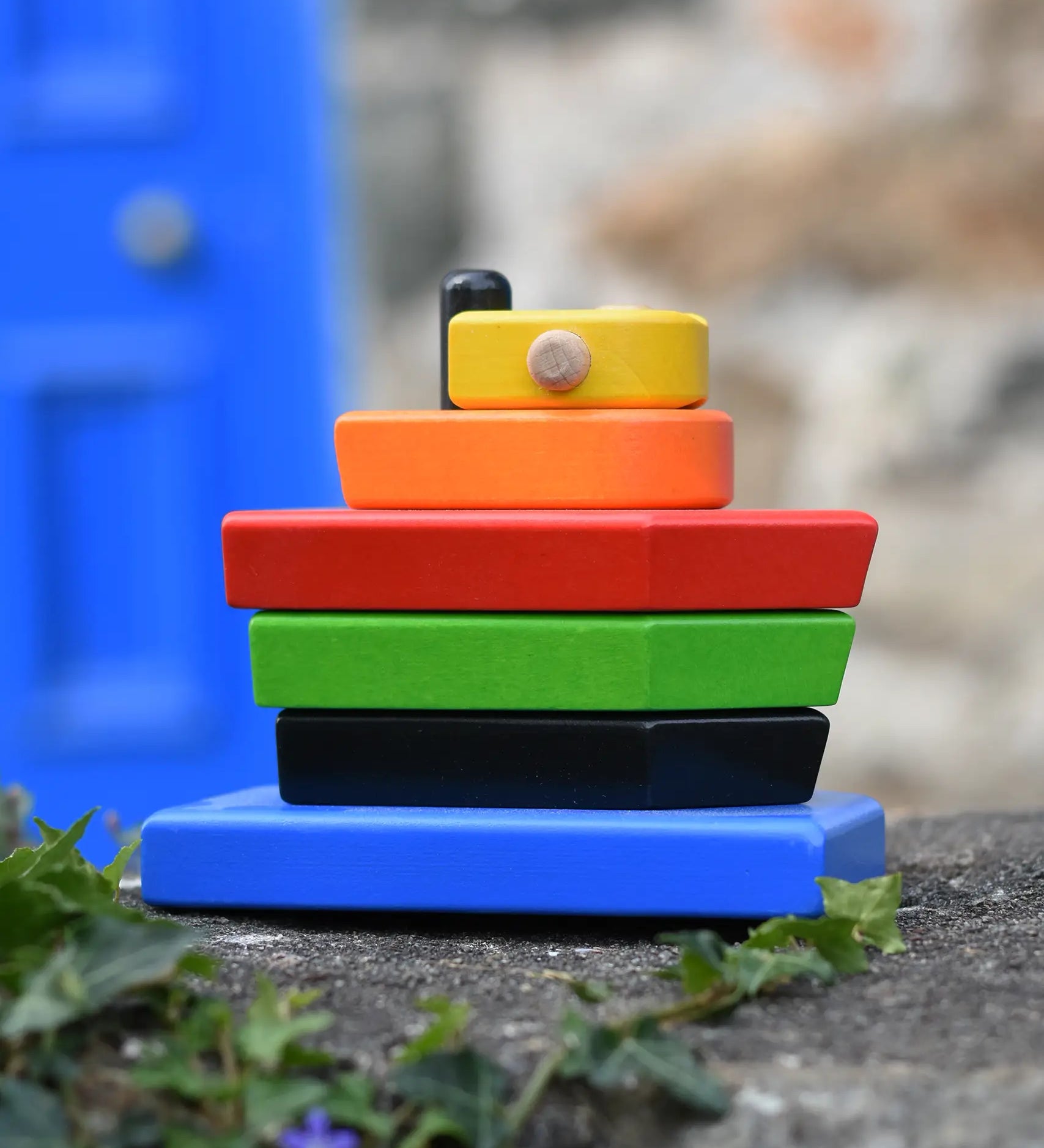 Bajo nemo boat stacker toy placed on a stone wall outdoors. 