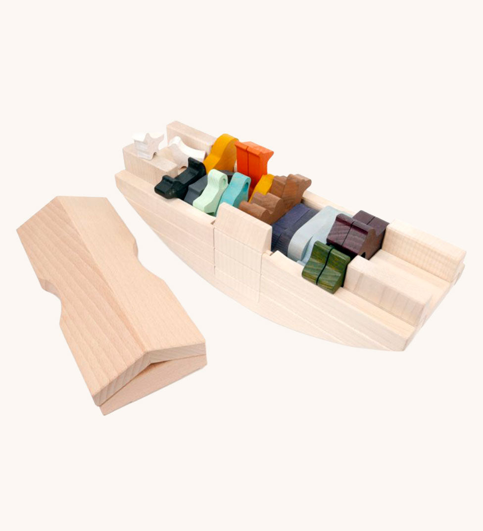 Coloured wooden animal figures placed inside the Bajo Noah's ark wooden toy. The ark is shown with the roof piece taken off and placed besides the rest of the boat. These heirloom quality toys by Bajo are part of a wide range of wooden toys available here at Babipur. 