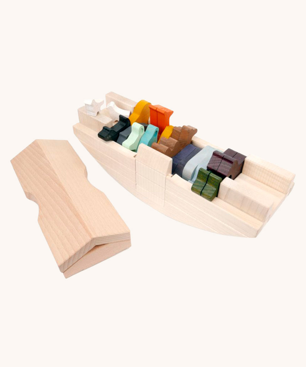 Coloured wooden animal figures placed inside the Bajo Noah's ark wooden toy. The ark is shown with the roof piece taken off and placed besides the rest of the boat. These heirloom quality toys by Bajo are part of a wide range of wooden toys available here at Babipur. 