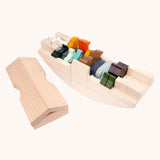 Coloured wooden animal figures placed inside the Bajo Noah's ark wooden toy. The ark is shown with the roof piece taken off and placed besides the rest of the boat. These heirloom quality toys by Bajo are part of a wide range of wooden toys available here at Babipur. 