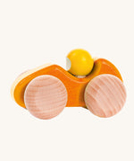 An orange coloured Bajo wooden racing car, the car has natural wooden wheels. This car is part of a wide range of Bajo wooden toy vehicles available at Babipur.