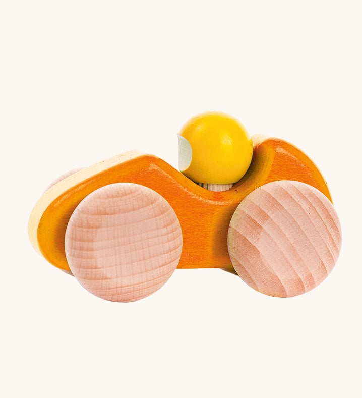 An orange coloured Bajo wooden racing car, the car has natural wooden wheels. This car is part of a wide range of Bajo wooden toy vehicles available at Babipur.