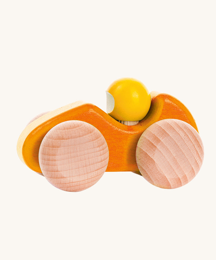 An orange coloured Bajo wooden racing car, the car has natural wooden wheels. This car is part of a wide range of Bajo wooden toy vehicles available at Babipur.