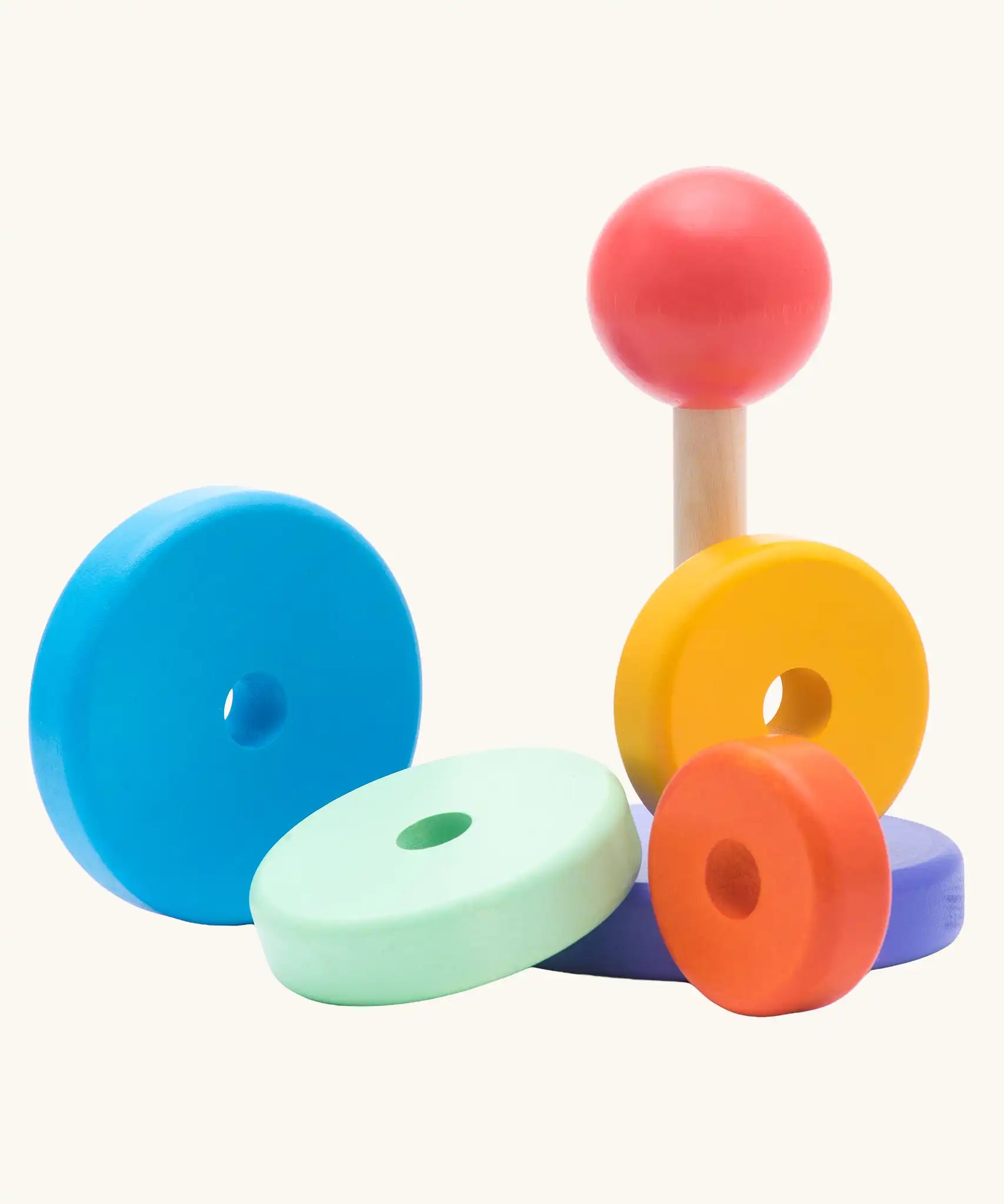 Bajo pastel stacker pyramid wooden stacking toy with the pieces taken off the base.