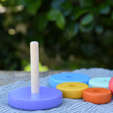 Bajo pastel stacking rings wooden toy shown with the wooden ring . s taken off the base pole.
