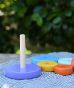 Bajo pastel stacking rings wooden toy shown with the wooden ring . s taken off the base pole.