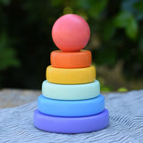 Bajo pastel stacking rings wooden toy. Purple base with pole, blue, green, yellow and orange rings with a pink red all pieces on top.