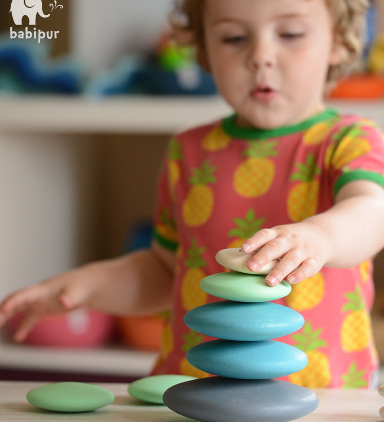 Build and stack with these wonderfully smooth and tactile 10 round wooden Pebbles by Bajo in shades of blue