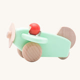 A Bajo mint wooden plane toy with pilot. The mint coloured plane has natural wheels, propeller and tail and a red coral coloured pilot. This plane is part of a wide range of Bajo wooden toy vehicles available at Babipur.