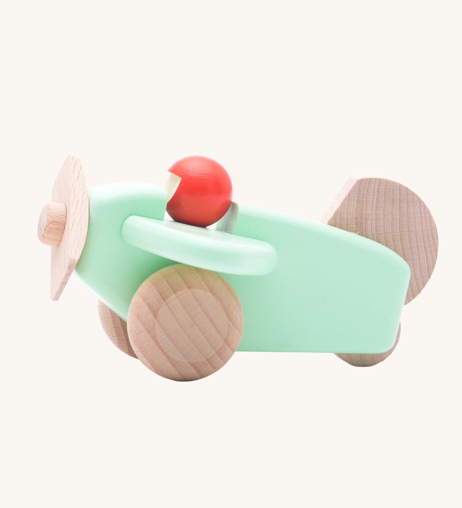 A Bajo mint wooden plane toy with pilot. The mint coloured plane has natural wheels, propeller and tail and a red coral coloured pilot. This plane is part of a wide range of Bajo wooden toy vehicles available at Babipur.