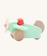 A Bajo mint wooden plane toy with pilot. The mint coloured plane has natural wheels, propeller and tail and a red coral coloured pilot. This plane is part of a wide range of Bajo wooden toy vehicles available at Babipur.