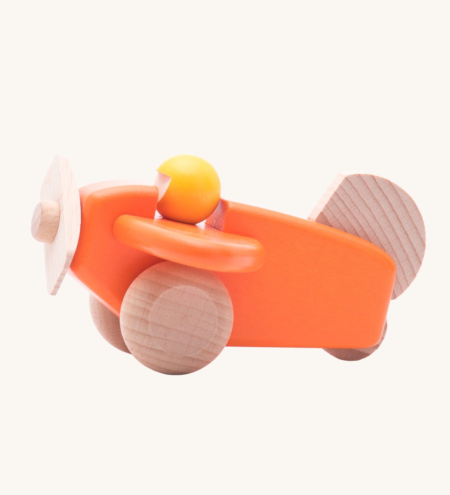 A Bajo orange wooden plane toy with pilot. The orange coloured plane has natural wheels, propeller and tail and a yellow coloured pilot. This plane is part of a wide range of Bajo wooden toy vehicles available at Babipur.