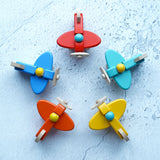 Five Bajo toy planes with pilots placed in a circled pictured from above. These planes is part of a wide range of Bajo wooden toy vehicles available at Babipur.