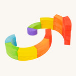 Bajo plastic-free wooden rainbow blocks laid out in 2 spirals on a white background