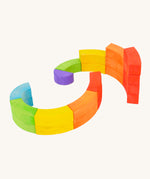 Bajo plastic-free wooden rainbow blocks laid out in 2 spirals on a white background