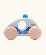 Side profile view of Bajo silver police car wooden toy vehicle. Silver car with blue details and natural wooden wheels.