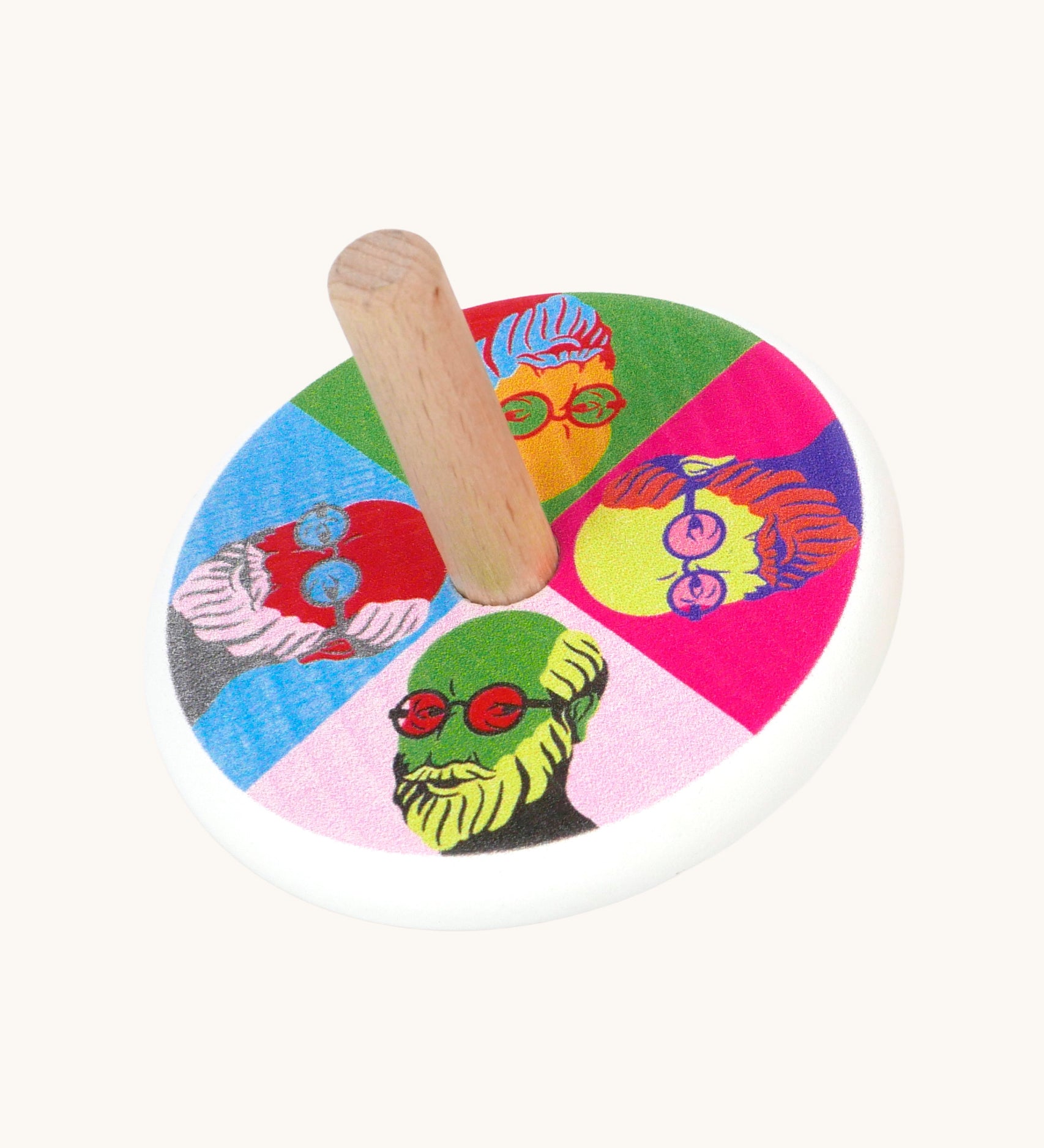 A Bajo Pop Art wooden Spinning Top toy. A white painted body with a natural wooden stick. The top of the spinning top has a colourful pop are design featuring the face of Mr Bajor.