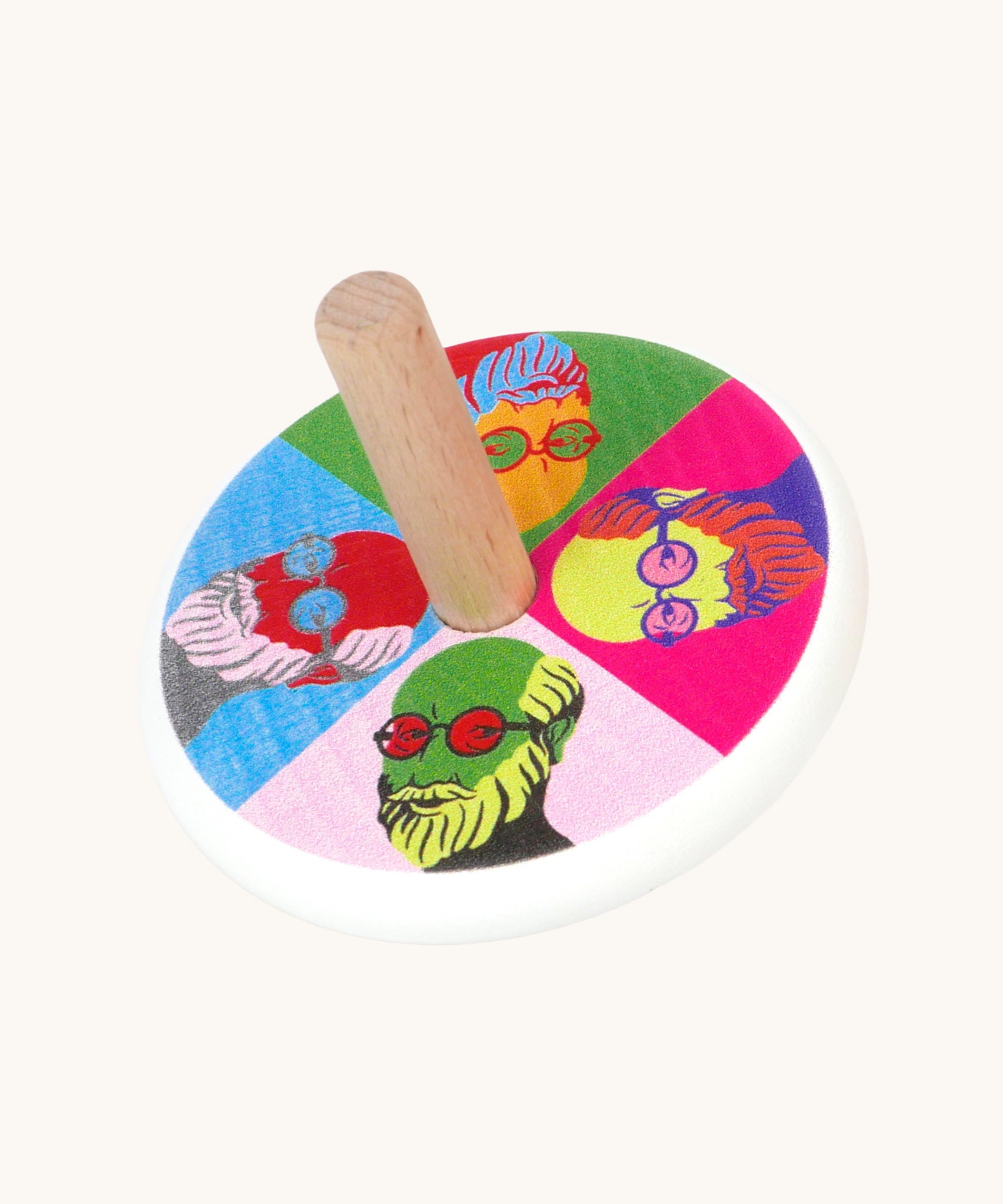 A Bajo Pop Art wooden Spinning Top toy. A white painted body with a natural wooden stick. The top of the spinning top has a colourful pop are design featuring the face of Mr Bajor.