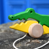 Close up of the face of the Bajo pull along crocodile wooden toy.
