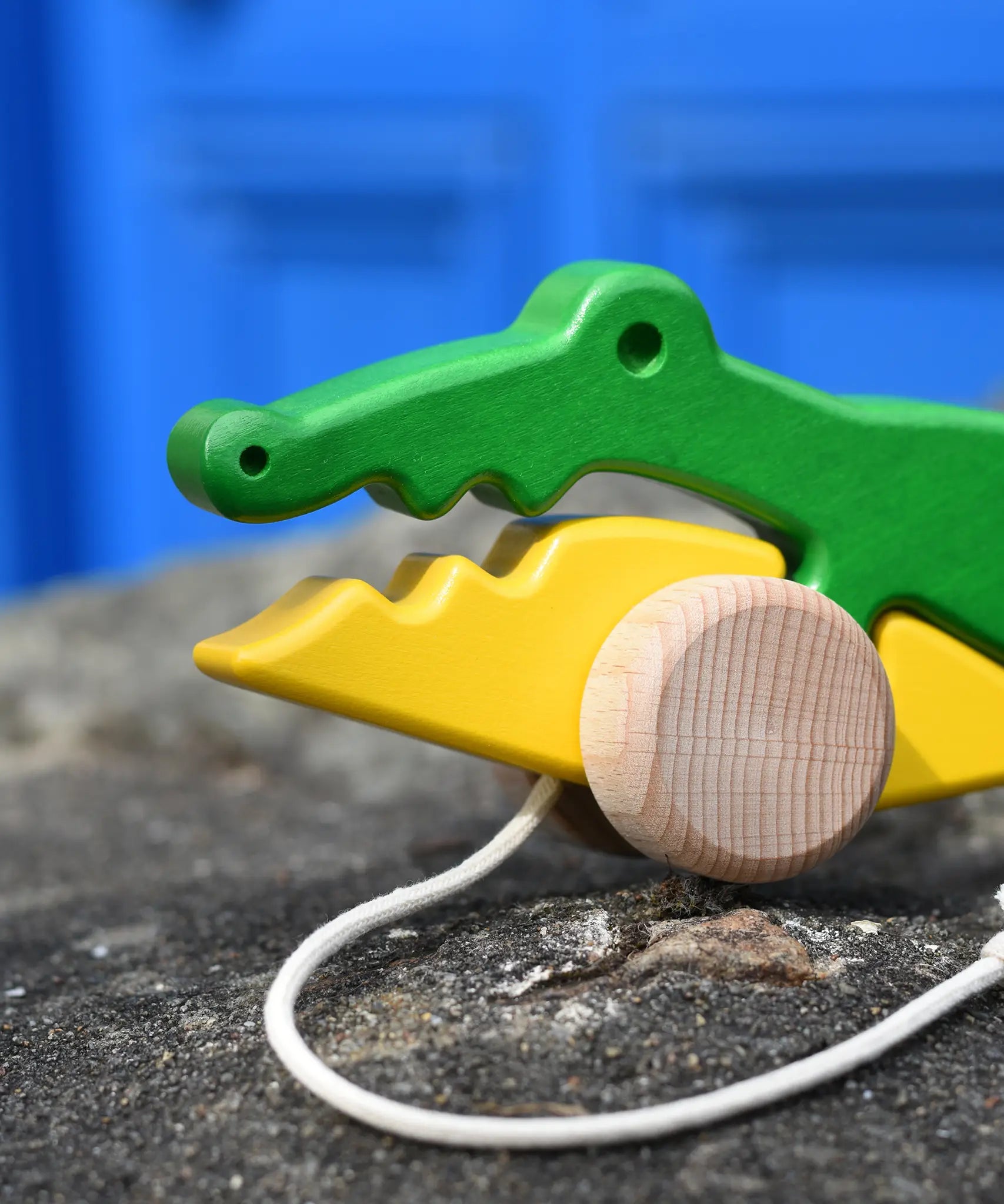 Close up of the face of the Bajo pull along crocodile wooden toy.