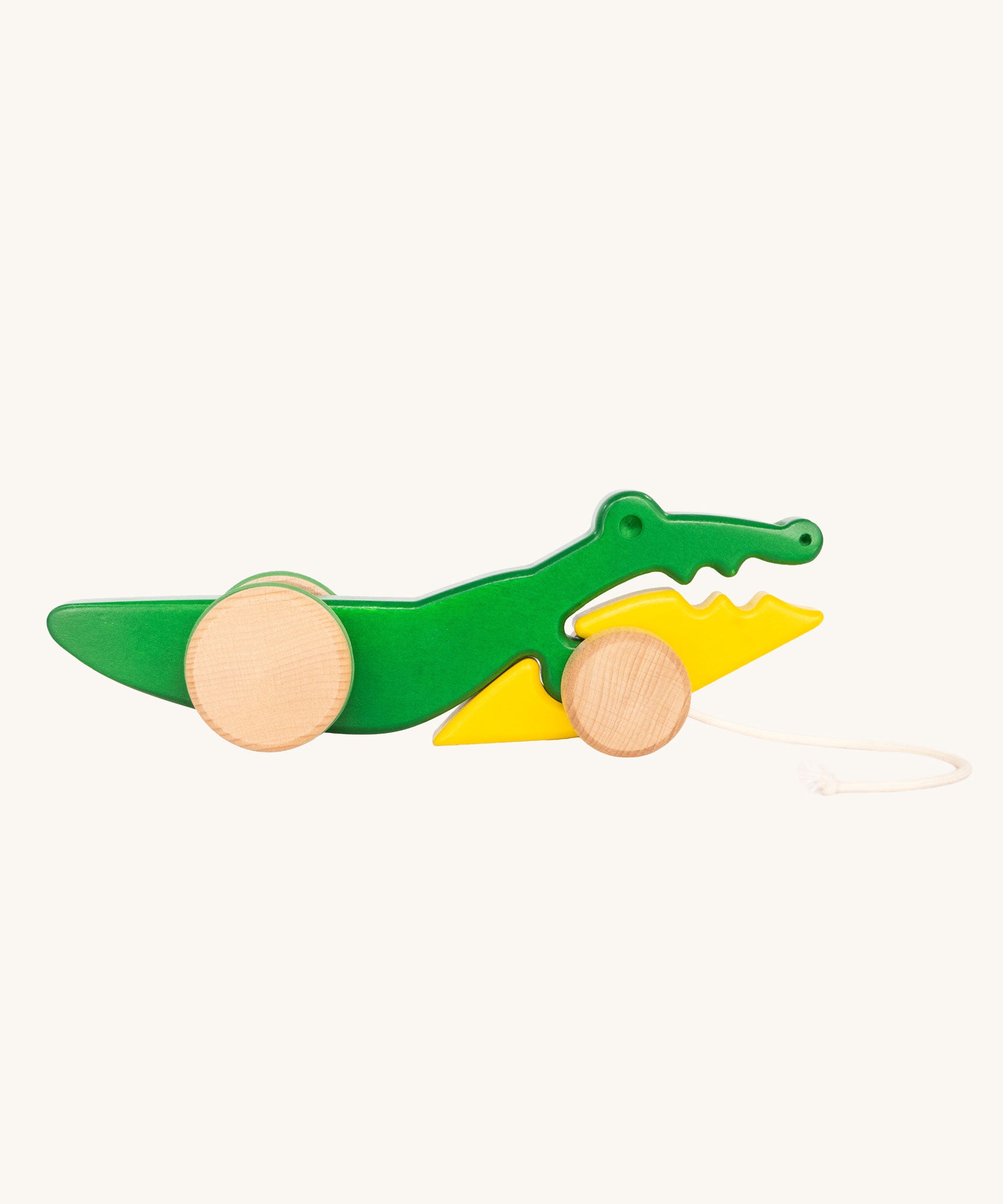 Bajo Pull Along Crocodile wooden toy.  A green and yellow crocodile on natural wooden wheels with a string attached to the front.
These heirloom quality toys by Bajo are part of a wide range of wooden toys available here at Babipur. 