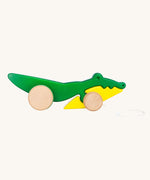 Bajo Pull Along Crocodile wooden toy.  A green and yellow crocodile on natural wooden wheels with a string attached to the front.
These heirloom quality toys by Bajo are part of a wide range of wooden toys available here at Babipur. 