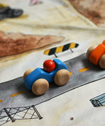 A blue Bajo racing cars  placed on a Wonderie building site play cloth. These heirloom quality toys by Bajo are part of a wide range of wooden toys available here at Babipur. 