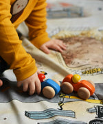 A child playing with the Bajo racing cars that have been placed on a Wonderie building site play cloth. These heirloom quality toys by Bajo are part of a wide range of wooden toys available here at Babipur. 