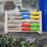 Bajo 50 bead wide abacus placed on a stone wall.