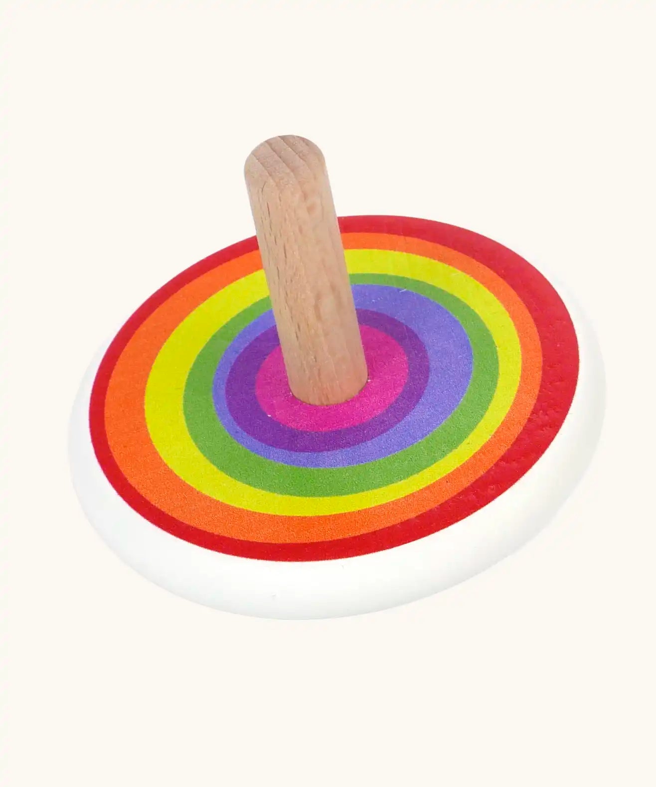 Bajo Rainbow Spinning Top. A white painted body with a rainbow design on the top and a natural wooden handle.