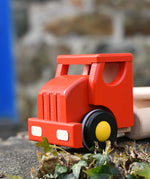 Front of the Bajo large red cargo truck and wooden shape sorter toy.