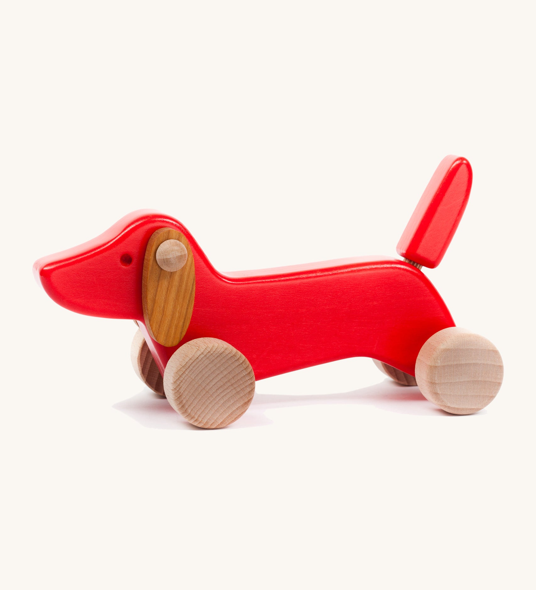 Bajo wooden red dachshund puppy available at Babipur. Features unpainted wheels to push and pull