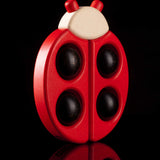 Bajo Red Ladybird Teether shown on a black background.