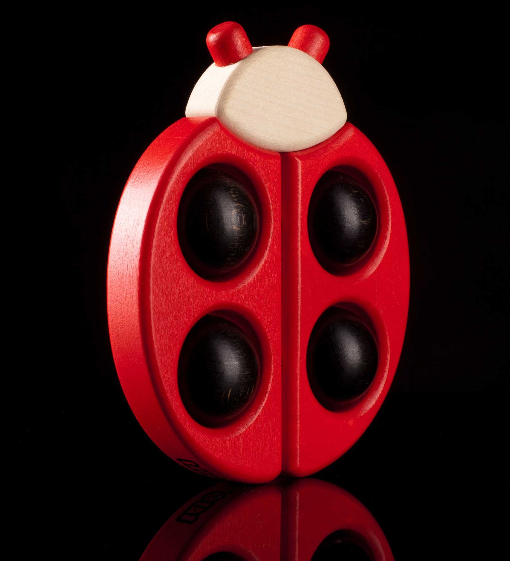 Bajo Red Ladybird Teether shown on a black background.
